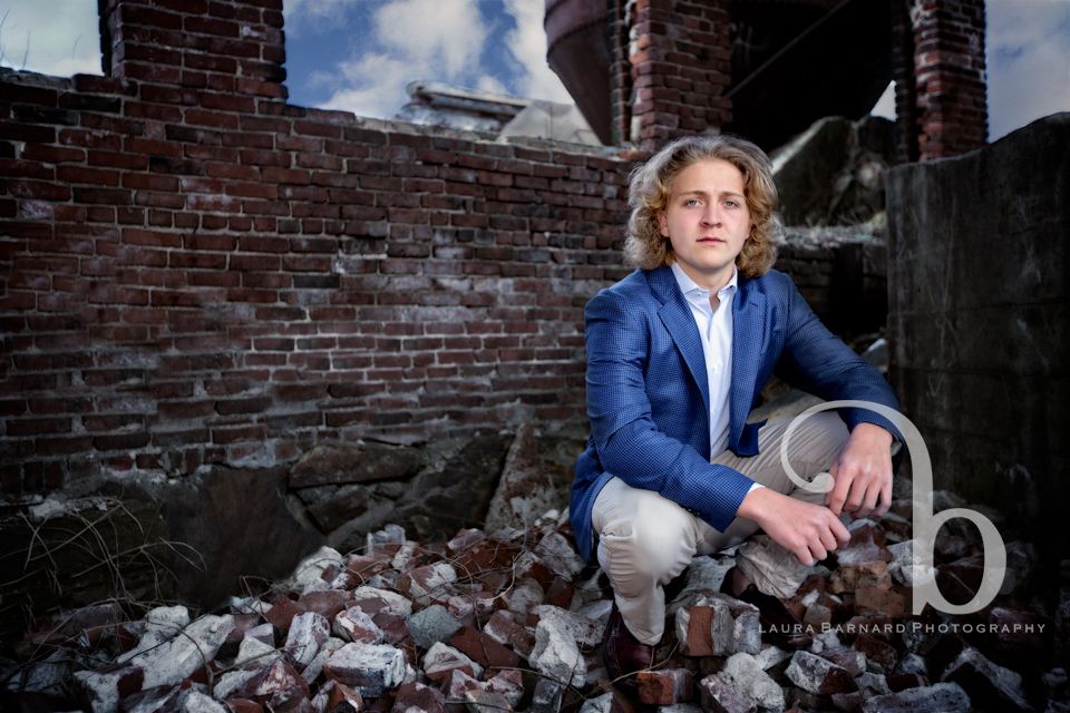 A senior portrait among brick ruins.